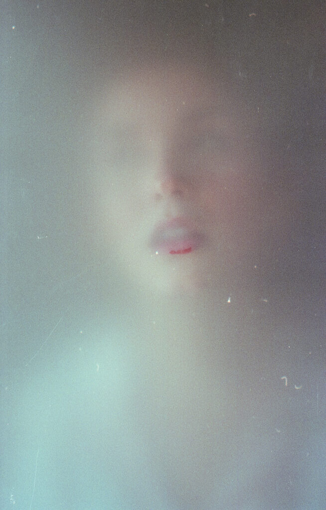 Film Photo of Miranda Valdez a model with a soft focus and vintage aesthetic capturing her face and lips.